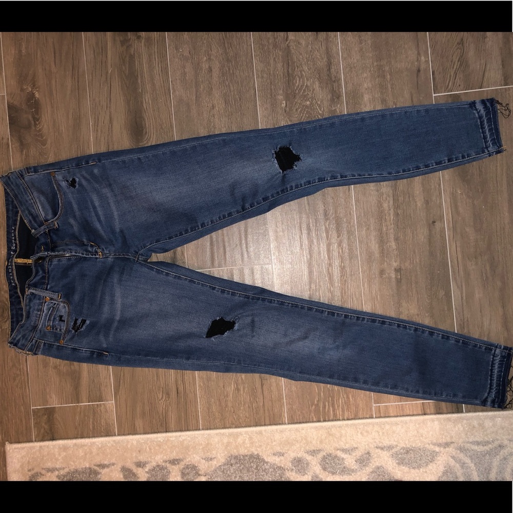 Denim jeans with black holes in knees